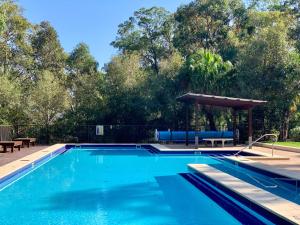 a swimming pool with a gazebo in a yard at Treescape by the Lake in Murrays Beach