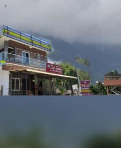a building with a view of a mountain in the background at Teja Residency in Alāndurai +25 photos