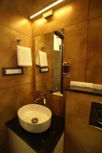 a bathroom with a sink and a mirror at Pabis luxurious stay in Vythiri