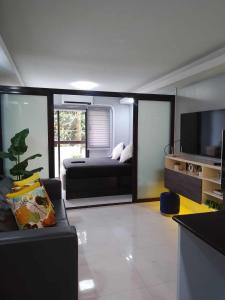 a living room with a couch and a television at Aloha Hale One Oasis Cdo in Cagayan de Oro