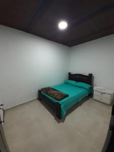 Ένα ή περισσότερα κρεβάτια σε δωμάτιο στο El cafetero hospedaje