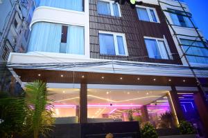 a building with purple lights in front of it at Pipul Ocean View Resort in Puri