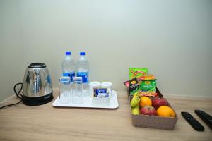 a table with bottles of water and a blender and fruit at Pipul Ocean View Resort in Puri