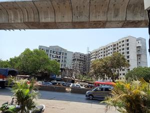 a view of a parking lot with cars and buildings at Hotel BKC Palace Inn - Jio world convention center and us visa center హోటల్ బి కే సి ప్యాలెస్ ఇన్ in Mumbai