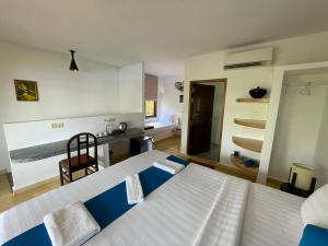 a bedroom with two beds and a kitchen in it at Kep Lodge in Kep