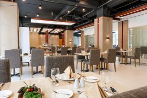 a dining room with tables and chairs in a restaurant at Sotogrande Hotel Baguio in Baguio