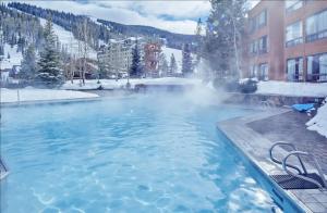 a pool of water with snow on the ground at Shoshone by DC in Big Sky