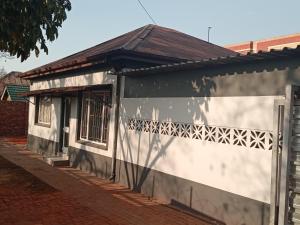 a small building with a fence in front of it at Las Palmas Day & Night Guest House in Pretoria