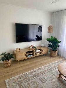 Μια τηλεόραση ή/και κέντρο ψυχαγωγίας στο Modern Beach home with large private gardens
