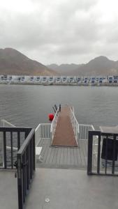 a dock in the middle of a body of water at Sunset villa in Fujairah