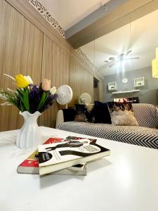 a living room with a vase of flowers on a table at Fully equipped 1BR Condo at Shore2 near to MOA in Manila