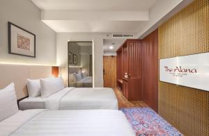 Postel nebo postele na pokoji v ubytování The Alana Hotel Malang + 37 fotografií