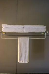 a towel rack with white towels on it in a bathroom at Winter Note Resorts in Munnar +37 photos