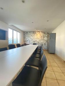 a conference room with a large white table and chairs at L'auberge Angevine in Angers