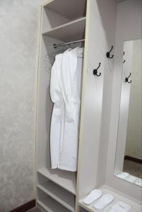 a closet with white towels and a mirror at IMPERIAL in Taraz