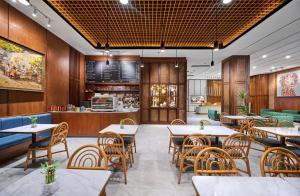 a restaurant with tables and chairs and a counter at The Alana Hotel Malang in Malang
