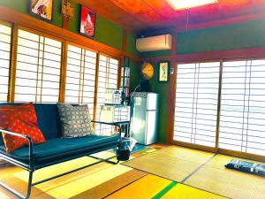 a living room with a couch and a refrigerator at HS japan house in Ichiba