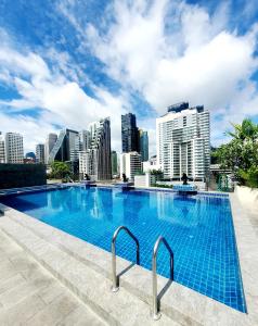 a swimming pool with a city skyline in the background at Admiral Premier Bangkok in Bangkok