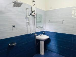 a blue and white bathroom with a sink and shower at Ayubowan, Ella in Ella +138 photos