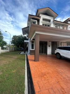 a white car parked in front of a house at Abang payung sierra perdana in Masai