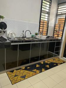 a kitchen with a sink and a counter top at Abang payung sierra perdana in Masai