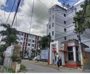 a building on a street with a person standing next to it at Cebu City 2 Bedroom Condo Unit-WIFI-A/C-Hot Shower (U404) in Cebu City