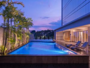 a swimming pool in the backyard of a house at ASTON Inn Tasikmalaya in Tasikmalaya