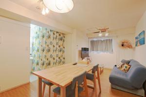 a living room with a wooden table and a couch at V.Close to Shinjuku Kabukicho/Korean Town/FrWIFI A in Tokyo