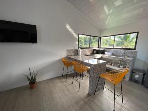 a kitchen with a table and chairs in a room at ShaBere in Talamanca