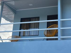 a balcony with chairs and windows on a house at ShaBere in Talamanca