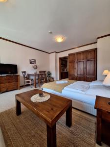 a large bedroom with two beds and a table at Cozy studio with balcony in 4-star hotel Saint Ivan Rilski, Bansko in Bansko