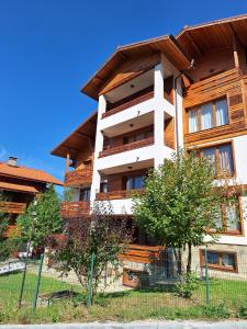 a building with a fence in front of it at Cozy studio with balcony in 4-star hotel Saint Ivan Rilski, Bansko in Bansko