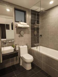 a bathroom with a toilet and a tub and a sink at GentingPeak8pax3BR110@IonDelemen in Genting Highlands