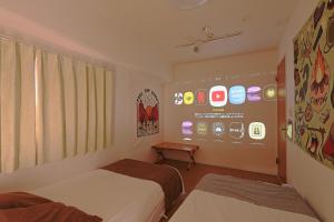 东京V.Close to Shinjuku Kabukicho/Korean Town/FrWIFI D的一间设有两张床和iphone显示器的房间