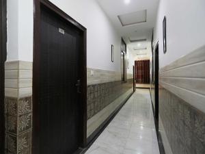 a hallway with a black door in a building at Collection O Hotel RV Palace in Agra