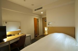 Postel nebo postele na pokoji v ubytování Hotel Sunflex Kagoshima