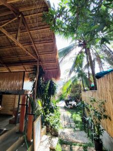 an outside view of a resort with a palm tree at Nomad Yurts in Coron