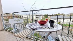 - une table blanche avec un bol sur le balcon dans l'établissement ☆ Le Nid de Coton ☆ Balcon ☆ Calme ☆ Fibre ☆ Relax BNB ☆, à Pfastatt