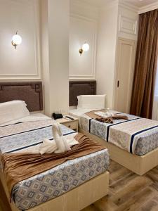 a bedroom with two beds with towels on them at El Farida Hotel in Cairo