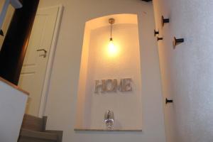a hallway with a home sign on the wall at Welcome-Home-Radeberg in Radeberg