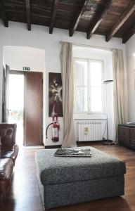 a bedroom with a bed and a couch and two windows at ComeCasa Da Chiaretta in Milan