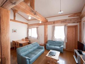 a living room with a couch and a table at Silver Birch in Niseko