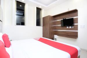 a bedroom with two beds and a tv at OYO Hotel Prabhat in Zirakpur