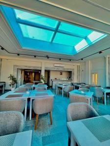 a dining room with tables and chairs and a skylight at El Farida Hotel in Cairo