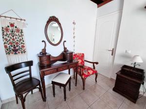 a room with a desk and a chair and a mirror at Forestata Village in Lixouri