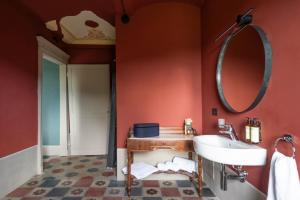 a bathroom with a sink and a mirror at NEW! Vigne di Fagnano 1709 Eco Relais in Santo Stefano Belbo