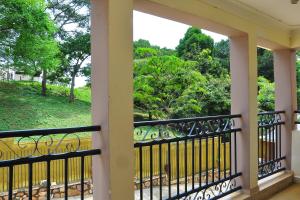 Elle comprend un balcon offrant une vue sur un parc. dans l'établissement Namulanda Motel, à Entebbe