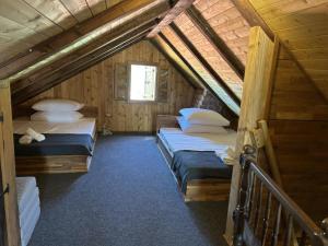 a room with three beds in a wooden cabin at Le’Klet in Marija Gorica