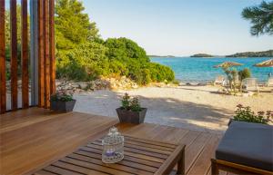 a wooden deck with a view of the beach at Paradisum sub sole in Tisno