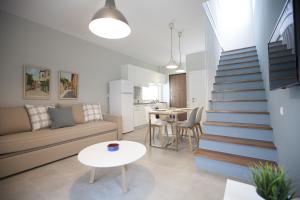 a living room with a staircase leading up to a kitchen at Enalia Villas in Ierissos